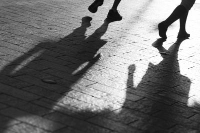 Low section of people walking on street