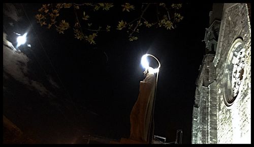 Low angle view of illuminated street light at night