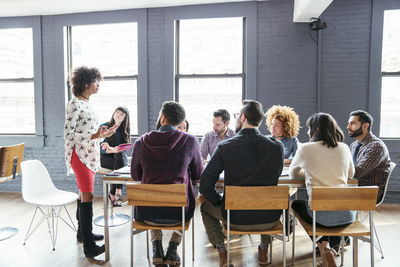 Coworkers planning at table in office