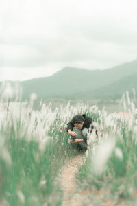 Portrait of man with his camera in the middle of white reeds