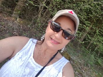 Portrait of beautiful young woman wearing sunglasses outdoors