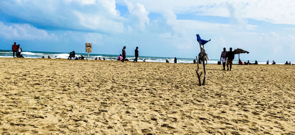 People on beach against sky