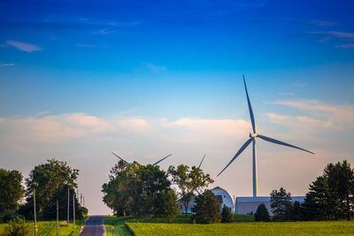 Traditional windmill on field against sky