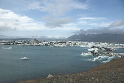 Scenic view of sea against cloudy sky