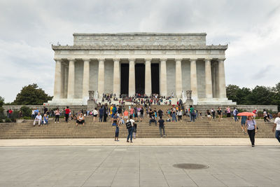 People in front of historical building