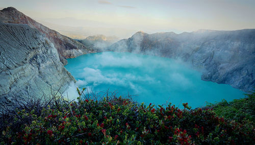 Scenic view of lake and mountains against sky