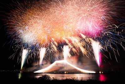 Low angle view of firework display at night