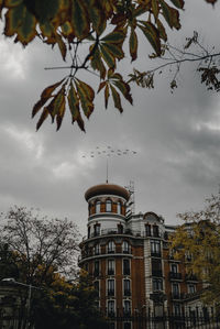 Low angle view of building against cloudy sky