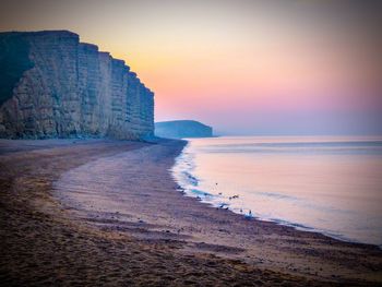 Scenic view of sea against clear sky during sunrise 