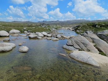 Scenic view of rocks in lake against sky