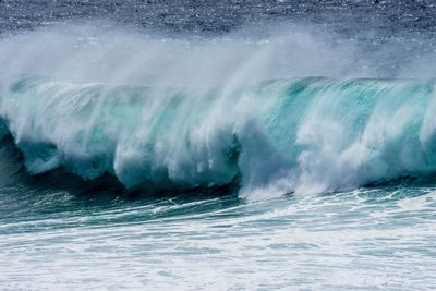 Close-up of huge waves crashing at sea