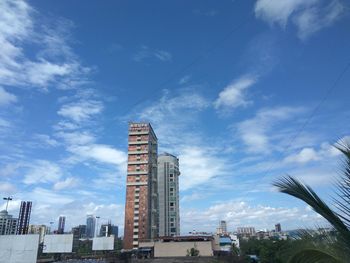 Low angle view of buildings against blue sky