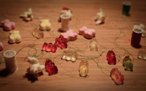 Close-up of gummy bears and strings on table during christmas