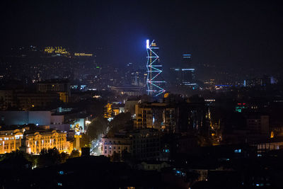 High angle view of city lit up at night