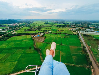 Low section of person on landscape against sky