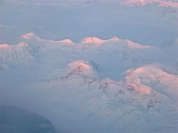 Aerial view of snowcapped mountain against sky