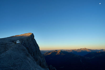 Scenic view of snowcapped mountains against clear blue sky