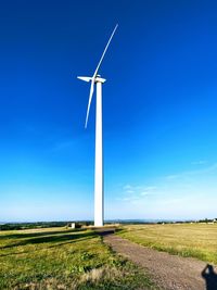 Windmill on field against sky