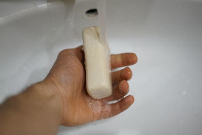 Close-up of human hand holding bathroom