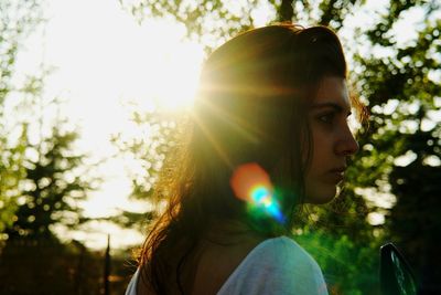 Close-up portrait of woman against tree