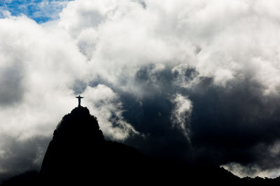 Low angle view of church against cloudy sky