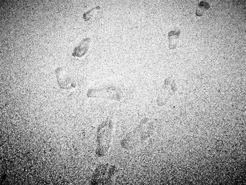 High angle view of footprints on sand