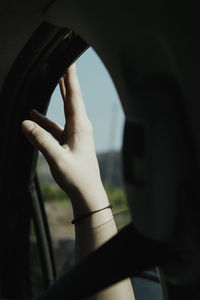 Midsection of person seen through car windshield