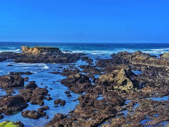 People below hunting for sea glass in the sand. glass beach in northern california.