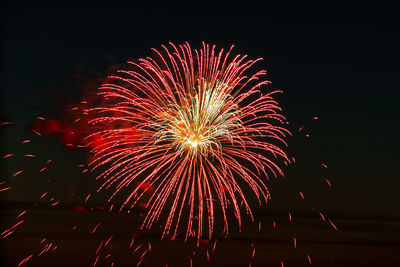 Low angle view of firework display at night