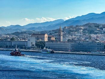 Scenic view of sea and mountains against sky