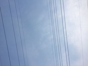 Low angle view of cables against sky