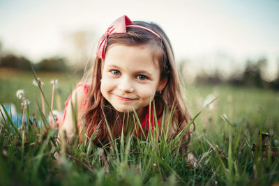 Portrait of cute girl smiling on field