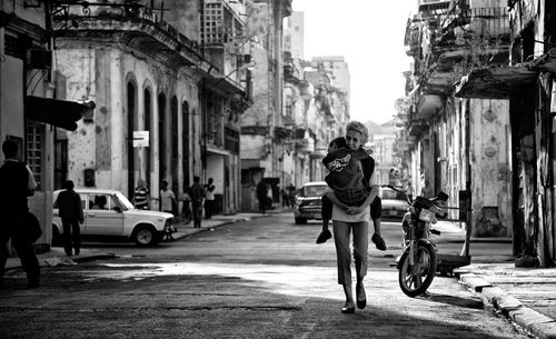 Full length of woman walking on street in city