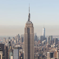 Modern buildings in city against clear sky