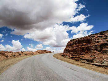 Empty road along countryside landscape