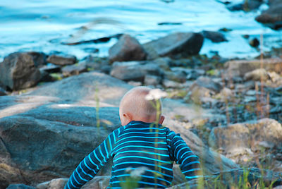 Rear view of a man on rock