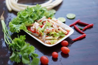 High angle view of chopped fruits in plate on table