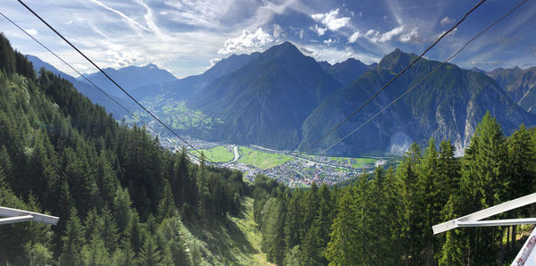 Panoramic view of trees and mountains against sky