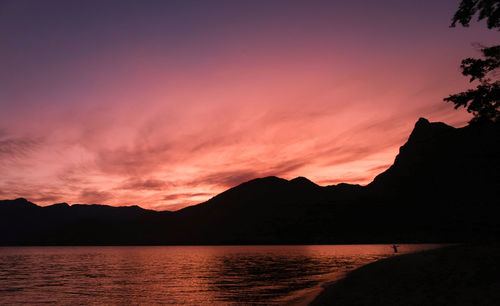 Scenic view of lake against romantic sky at sunset