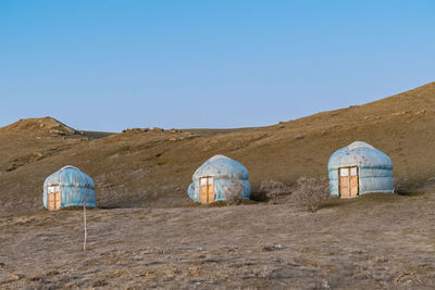 Yurt camp against blue sky at the edge of the aral sea, uzbekistan