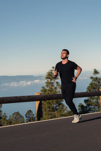 Young man running on road