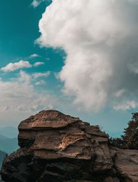 Low angle view of rock formation against sky