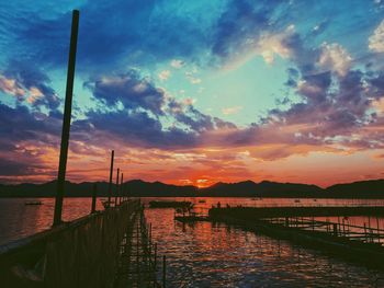 Pier on sea at sunset