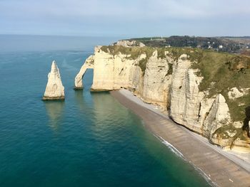 Panoramic view of sea and rock formation against sky