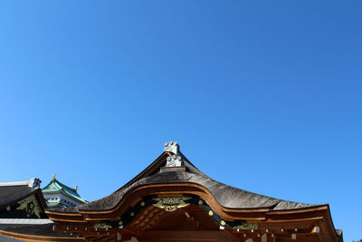 Low angle view of temple against clear blue sky