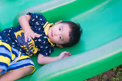 High angle view of cute boy playing on play equipment at park