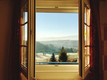 Scenic view of mountains seen through window