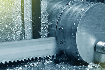 Close-up of water drops on pipe in factory