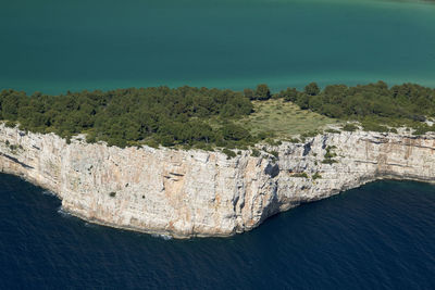 High angle view of trees by sea against sky