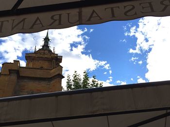 Low angle view of building against cloudy sky